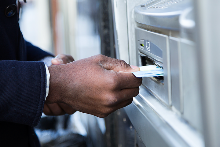 Man inserting card into ATM machine