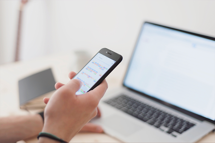 Cellphone calendar app and laptop
